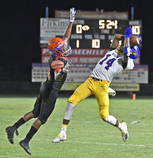 Bayshore High's Le'Quayvaious Greene, right, catches a 32-yard pass in the second quarter of the Bruins' game against the Class 5A-District 11 rival Southeast High on Friday night at Paul Maechtle Field at John Kiker Memorial Stadium in Bradenton. [Herald-Tribune staff photo / Thomas Bender]