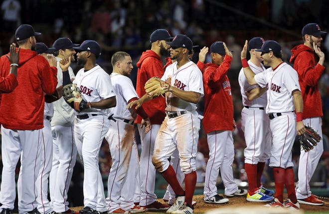 Red Sox players celebrate their 4-3 victory over the Blue Jays on Thursday night — their 101st win of the season.