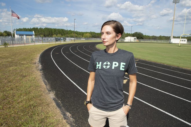 Mindi Iannarelli stands on the track of Pedro Menendez High School, south of St. Augustine, where she is helping to put on the "Out of the Darkness Walk" on Nov. 17 to help bring public awarness to the issue of suicide. [PETER WILLOTT/THE RECORD]