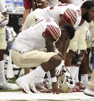 Florida State's James Blackman is dejected on the sideline in the final minutes of the Seminoles' 30-7 loss to Syracuse at the Carrier Dome in Syracuse, N.Y., Saturday. [The Associated Press / Nick Lisi]
