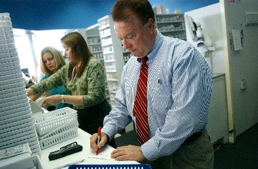 Pharmacist John Calhoun, owner of Cape Fear Discount Drugs, at his business on Raeford Road in 2007. [File photo/The Fayetteville Observer]