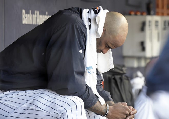 Yankees pitcher CC Sabathia sits on the bench after being taken out during the third inning of Saturday's game against the visiting Toronto Blue Jays. Sabathia was booed by the fans after another rough outing. He has won only one of his last 11 starts. [The Associated Press]