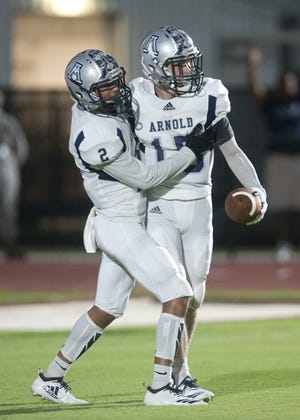 Arnold's Tyrin Jarmon (left) celebrates with Thomas Risalvato after scoring a touchdown in the first half of Friday's game at Tommy Oliver Stadium. [JOSHUA BOUCHER/THE NEWS HERALD]