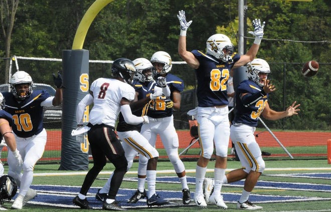 Siena Heights University football players celebrate during Saturday's game against Robert Morris at O'Laughlin Stadium.