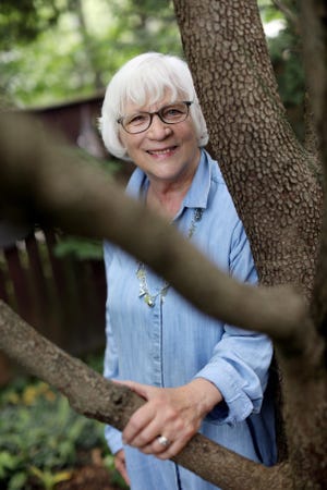 Judy Smithson-Hilkin is photographed in the backyard of her Burlington home. A retired teacher and guidance counselor, and one-time outdoor adventure guide, she maintains a love of nature around her and the stars above. [John Lovretta/thehawkeye.com]