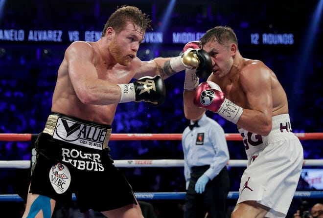 Canelo Alvarez, left, and Gennady Golovkin trade punches in the sixth round during a middleweight title boxing match, Saturday, Sept. 15, 2018, in Las Vegas. (AP Photo/Isaac Brekken)