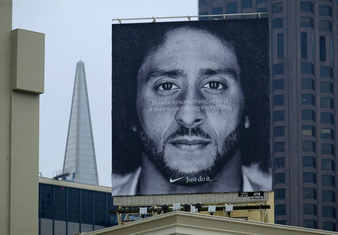 A large billboard stands on top of a Nike store showing former San Francisco 49ers quarterback Colin Kaepernick at Union Square, Wednesday, Sept. 5, 2018, in San Francisco.