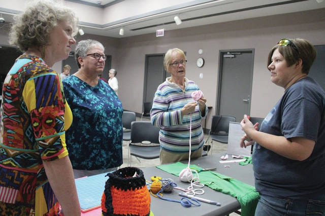 From left, Jill Cook, Maggie Ruggle and Luella Carney listen to Brittany Trotter talk about T-shirt yarn during a Craftastic Make-R-Day on Monday, Sept. 10. PHOTO BY ALLISON ULLMANN/THE PERRY CHIEF