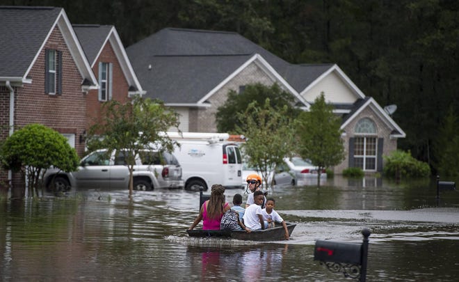 Pooler Fire Department boats residents of homes on Tappan Zee Drive after heavy flooding in the Pooler area due to Hurricane Matthew. [Savannah Morning News file photo]