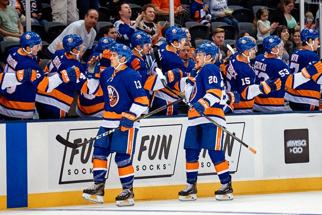 New York Islanders Kieffer Bellows, (20) celebrates with team mates after scoring, during the first period of a preseason NHL hockey game against Philadelphia Flyers in New York, Sunday, Sept. 16, 2018. (AP Photo/Andres Kudacki)