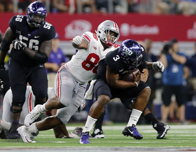 Ohio State Buckeyes defensive tackle Dre'Mont Jones (86) sacks TCU Horned Frogs safety Markell Simmons (3) during the 3rd quarter of their game at AT&T Stadium at Arlington, Texas on September 15, 2018. [Kyle Robertson]
