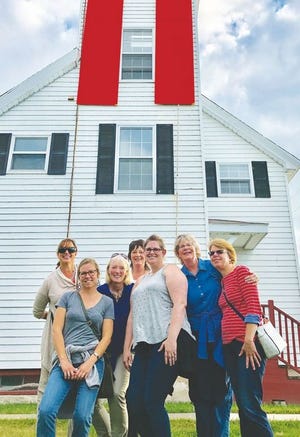 Staff from Citizens National Bank enjoyed an Explore Cheboygan tour last week, visiting various historical sites in the community, such as the Cheboygan Front Rage Light, seen here.