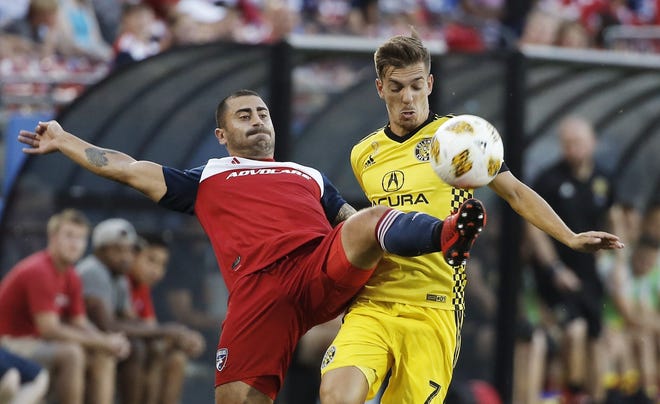 FC Dallas defender Marquinhos Pedroso, left, clears the ball away from Columbus Crew midfielder Pedro Santos (7) during the first half of an MLS soccer match, Saturday, Sept. 15, 2018, in Frisco, Texas. (AP Photo/Brandon Wade)