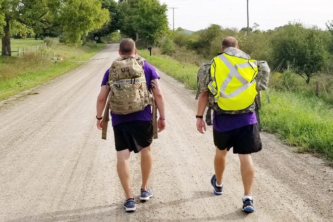 Scott Doney, left, and Tim Welbaum of Visiting Angels Senior Homecare marched 34 miles from Adrian to Ann Arbor while carrying 35 pounds on their backs in ruck sacks on Sept. 7, to raise donations and awareness toward ending Alzheimer's disease. They started at Visiting Angels in Adrian and ended at the Alzheimer's Association's Great Lakes Chapter in Ann Arbor.
