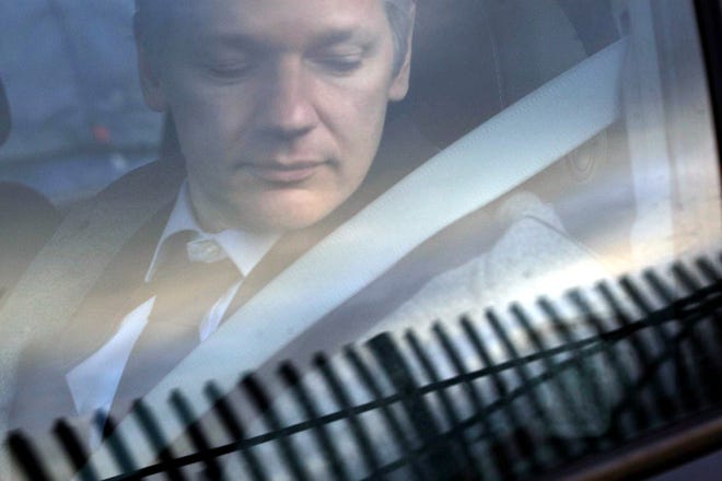 In this Jan. 11, 2011 file photo, WikiLeaks founder Julian Assange arrives at Belmarsh Magistrate’s court in London for an extradition hearing. According to a cache of internal WikiLeaks files obtained by The Associated Press, Assange sought a Russian visa and staffers at his radical transparency group discussed having him skip bail and escape Britain as authorities closed in on him in late 2010. [SANG TAN/ASSOCIATED PRESS]