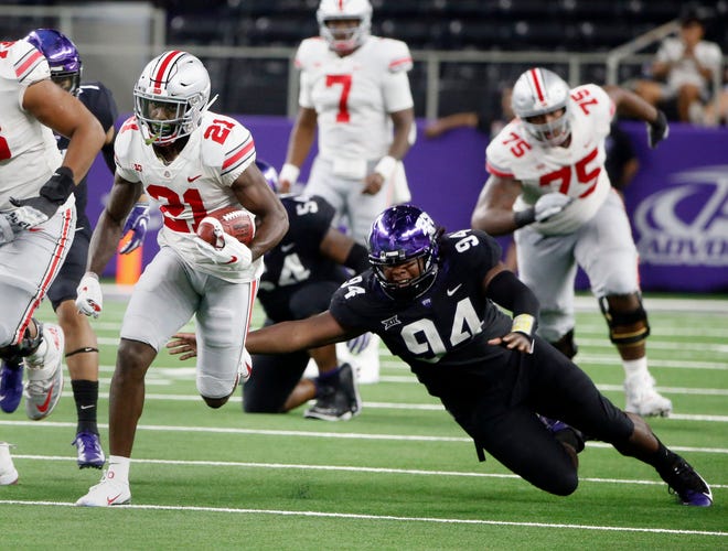 Ohio State wide receiver Parris Campbell (21) runs for a touchdown as TCU defensive tackle Corey Bethley (94) fails on a tackle attempt during the second half of an NCAA college football game in Arlington, Texas, Saturday, Sept. 15, 2018. (AP Photo/Michael Ainsworth)
