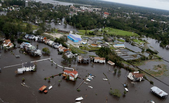 Homes and a marina are flooded as a result of high tides and rain from hurricane Florence which moved through the area in Jacksonville, N.C., Sunday, Sept. 16, 2018. (AP Photo/Steve Helber)