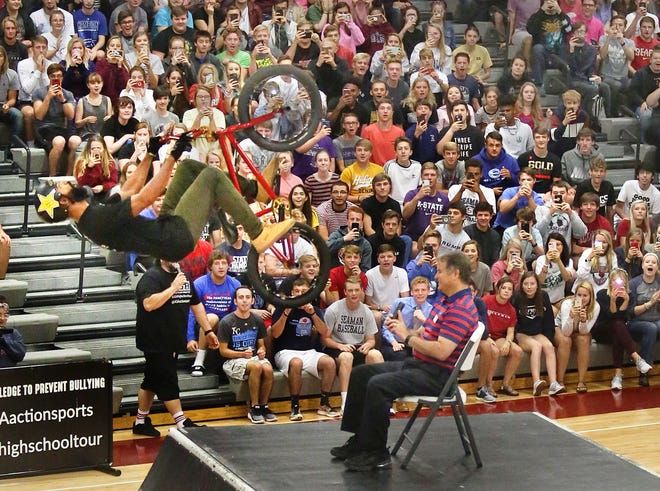 Seaman High School was the setting for a bullying prevention assembly with X-Games pros Monday morning. X Games bronze medalist Mikel Larrin flys over Principal Mike Monaghan in the events grand finale. [Thad Allton/The Capital-Journal]