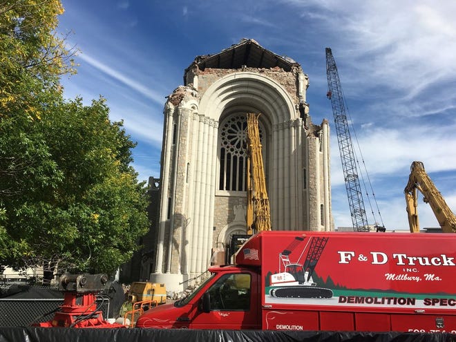 Crews have begun tearing down the building that once housed the Notre Dame Church in Worcester. The bell was removed last week.