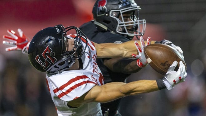 Lake Travis wide receiver Kyle Eaves (2) pulls down a catch over Bowie defensive back Terance Durst (2) during a District 25-6A high school football game at Tony Burger Center, Friday, Sept. 14, 2018. (Stephen Spillman / for American-Statesman)