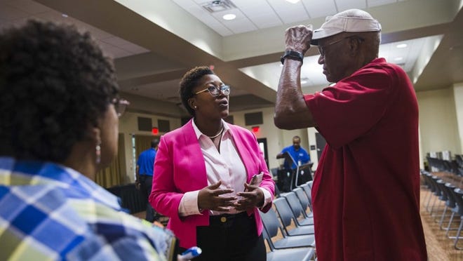 Candidate Natasha Harper-Madison, middle, chats with Johnnie, left, and Roscoe Overton, right, after the 2018 District 1 candidate forum Sept. 6. Harper-Madison rents a house on East 13th Street in East Austin’s District 1, which she seeks to represent, but records show she claims a homestead exemption on a house across town. She was registered to vote in Williamson County from 2008 to October 2017 and changed her registration to the East 13th Street house in November. AMANDA VOISARD / AMERICAN-STATESMAN