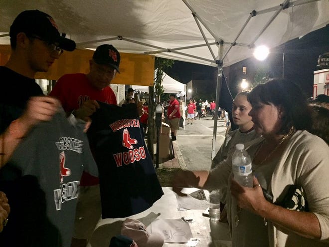 A customer chooses her jersey at the pop-up tend run by Guertin Graphics & Awards during Monday night's Worcester Red Sox celebration.