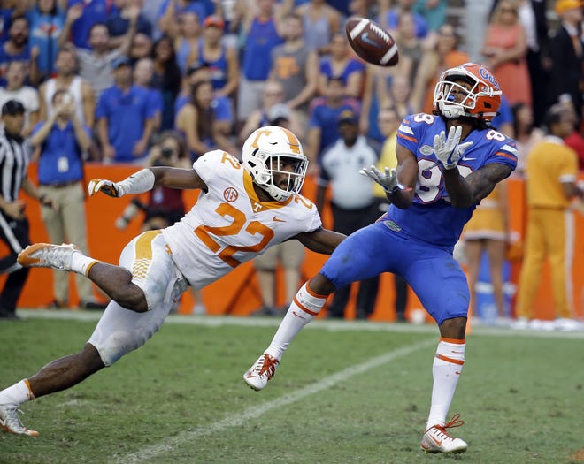 Florida wide receiver Tyrie Cleveland, right, catches the game winning 63-yard touchdown pass in front of Tennessee defensive back Micah Abernathy (22) as time expires on Sept. 16, 2017, in Gainesville. Florida won 26-20. [AP Photo/John Raoux]