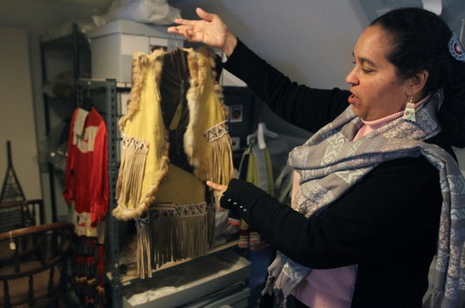 Loren Spears, executive director of the Tomaquag Museum in Exeter, holds a ceremonial outfit that she wore when she was about 8 years old and is now in storage waiting to be catalogued. Tomaquag is participating in Saturday's Free Museum Day. [The Providence Journal, file / Bob Breidenbach]