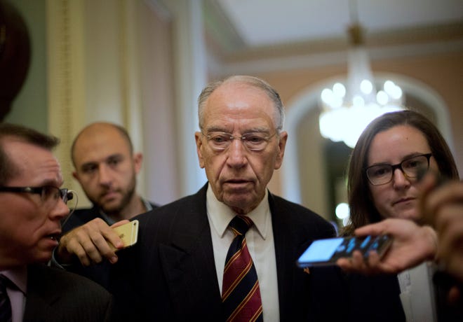 Sen. Chuck Grassley, R-Iowa, walks past members of the media as he heads to the Senate Chamber floor on Capitol Hill in Washington, D.C., on Tuesday. [THE ASSOCIATED PRESS]