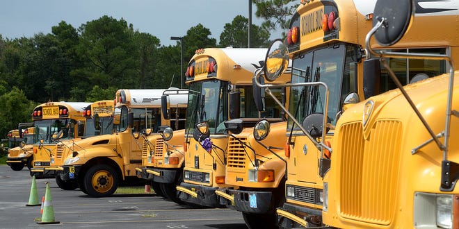 Some of the St. Johns County School District's buses sit in their transportation department's lot. The state pays about 65 cents on every dollar the district spends on busing. With St. Johns County adding more bus routes in the next school year, the amount it is paying to pick up the balance in 2018-19 is $875,000. [PETER WILLOTT/THE RECORD]