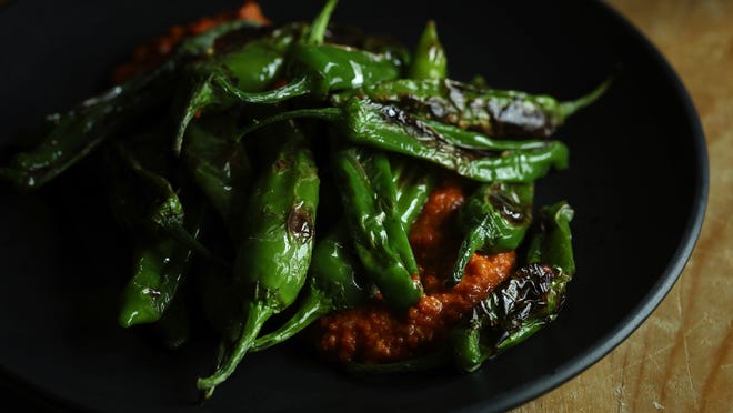A quick romesco sauce provides an unexpected base for seared shishito peppers.

[E. Jason Wambsgans/Chicago Tribune/TNS]