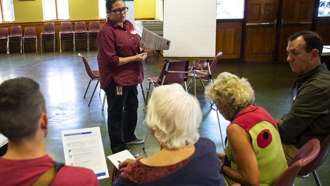 Mia Demers, a member of the police monitor’s office, leads a group discussion during a public meeting on police oversight at Our Lady of Guadalupe Parish in Austin on Wednesday. NICK WAGNER / AMERICAN-STATESMAN