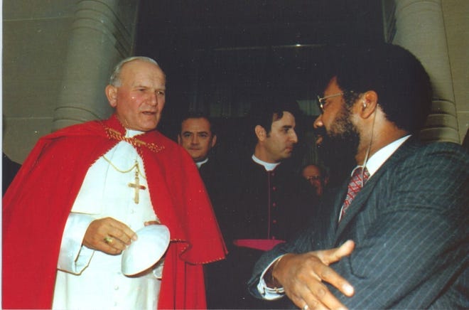 William James Montgomery Jr., right, works in a security detail for Pope John Paul II. Montgomery, a Columbus resident who died Aug. 29, was one of the first black Secret Service agents when he was hired in 1970. [Photo courtesy of family]