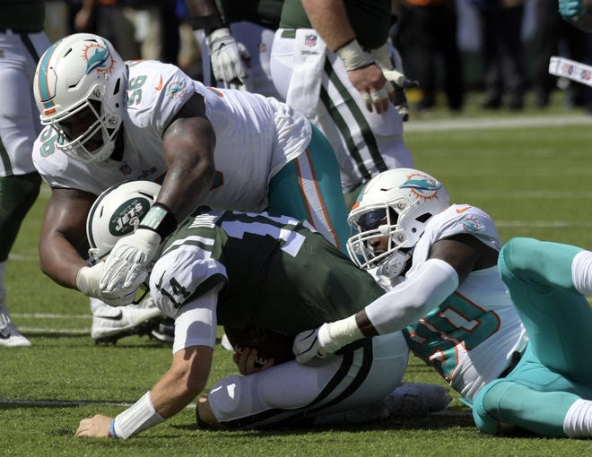 Miami Dolphins' Charles Harris (90) and Davon Godchaux (56) sack New York Jets' Sam Darnold (14) last week in East Rutherford, N.J. [AP Photo/Bill Kostroun, File]