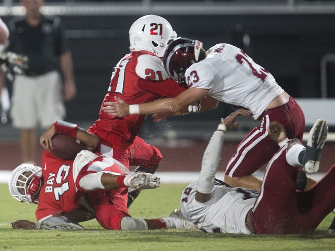 Bay quarterback Zy'Darrius Givens (13) goes down during Thursday's 61-6 loss to Chiles at Tommy Oliver Stadium. [JOSHUA BOUCHER/THE NEWS HERALD]