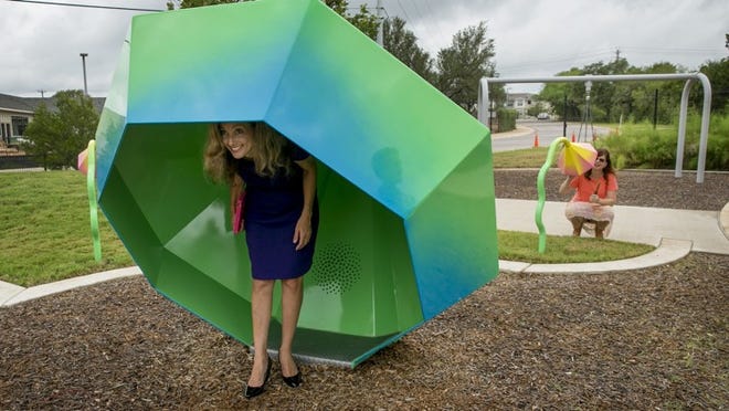 Austin City Council Member Kathie Tovo, left, and city of Austin Art in Public Places Coordinator Anna Bradley talk to each other through talking tubes at the grand opening of the newly renovated Austin Shelter for Women and Children on Friday. The talking tubes and a walk-in kaleidoscope are a new public art installation titled, Reflect and Resound, by artist Virginia Fleck. JAY JANNER / AMERICAN-STATESMAN