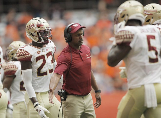 Florida State head coach Willie Taggart greets players coming off the field in the second quarter of a loss to Syracuse last week. [AP Photo/Nick Lisi]