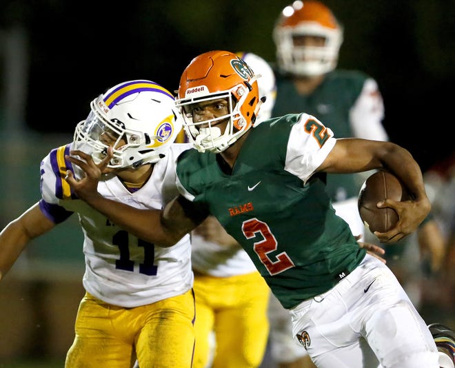 Eastside Rams quarterback Anthony Richardson (2) stiff arms Lake Weir defender Yanick Chin (11) as he runs the ball during a game between the Eastside Rams and the Lake Weir Hurricanes at Citizens Field in Gainesville Sept. 20, 2018. [Brad McClenny/ The Gainesville Sun]