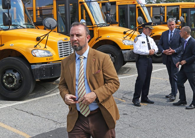 Providence School Superintendent Chris Maher leaves a press conference Friday where city and school officials discussed preparations for a bus drivers' strike. [The Providence Journal / Steve Szydlowski]