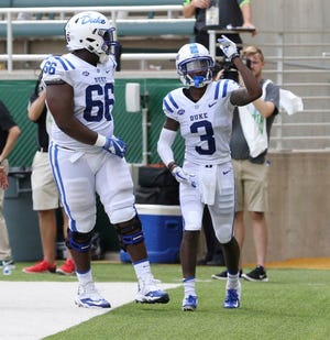 Duke receiver T.J. Rahming, right, celebrates a touchdown with offensive tackle Jaylen Miller last week at Baylor.