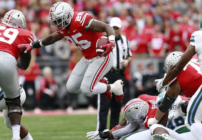 Ohio State running back Mike Weber hops over a pile in the first quarter. Weber suffered a right-foot injury in the second quarter and did not return to the game. [Brooke LaValley]