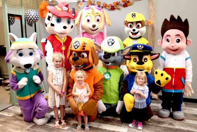 Paw Patrol came to visit downtown Cambridge on Saturday afternoon during Cambridge's Fall Festival. Pictured are Karlea Mathews, Kynlea Mathews and Morgan Miller with Paw Patrol's Everest, Zuma, Rocky, Chase, Marshall, Skye, Rubble and Ryder.