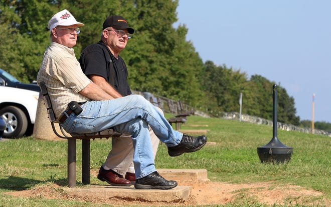 Roger Honeycutt, left, and Allen Johnson sit and watch the planes take off at the CLT Airport Overlook at Charlotte Douglas International Airport Friday morning, Sept. 21, 2018. [Mike Hensdill/The Gaston Gazette]