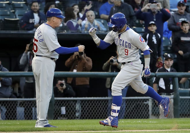 Chicago Cubs' Javier Baez, right, celebrates with third base coach Brian Butterfield after hitting a two-run home run against the Chicago White Sox during the first inning Saturday, Sept. 22, 2018, in Chicago. [NAM Y. HUH/THE ASSOCIATED PRESS]