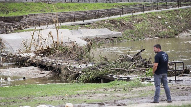 The Randy Marrow Trail and walkway across the San Gabriel River was closed Sunday after suffering debris and flood damage from Saturday’s storms. RICARDO B. BRAZZIELL / AMERICAN-STATESMAN