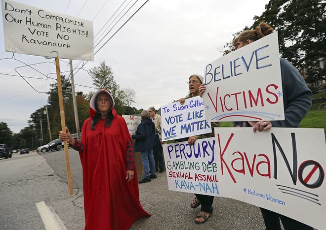 Opponents of Supreme Court nominee Judge Brett Kavanaugh demonstrate outside Saint Anselm College in Manchester, N.H., on Friday before a speech by Sen. Susan Collins. The Maine Republican is considered one of the few possible GOP no votes on Kavanaugh. [Elise Amendola/Associated Press]