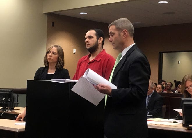 Attorneys Anna White (left) and Tom Smith (right) act as public defenders for Aaron Young, 26, (center) at the Ottawa County Circuit Court Dec. 26, 2017. Young, who was determined financially unable to pay for his own attorneys, was sentenced to prison for murder. Starting next year, a centralized public defender office will be established in Ottawa County. [Audra Gamble/Sentinel staff]