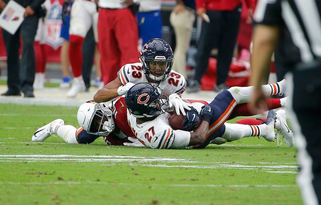 Chicago Bears defensive back Sherrick McManis (27) intercepts pass intended for wide receiver Chad Williams, left, as Bears defensive back Kyle Fuller (23) helps secure the ball during the second half of an NFL football game, Sunday, Sept. 23, 2018, in Glendale, Ariz. (AP Photo/Rick Scuteri)