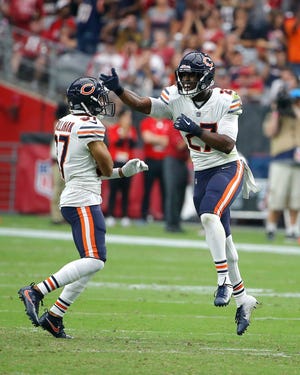 Chicago Bears defensive back Sherrick McManis (27) celebrates his interception against the Arizona Cardinals with Bryce Callahan, left, during the second half of an NFL football game, Sunday, Sept. 23, 2018, in Glendale, Ariz. (AP Photo/Rick Scuteri)