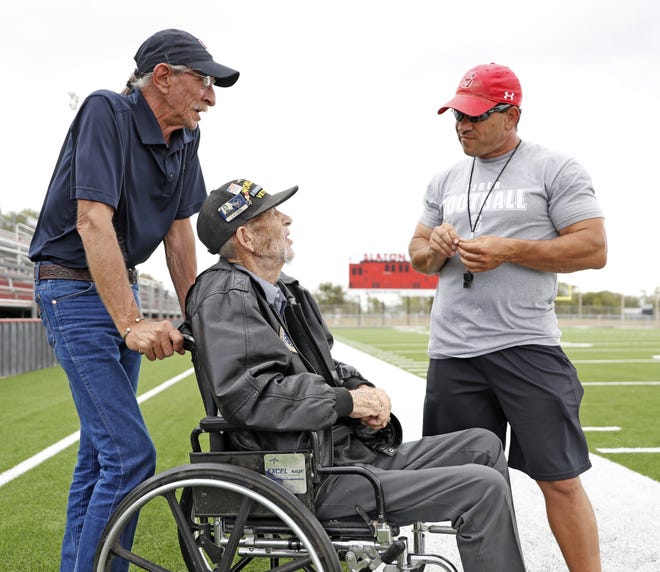 Slaton coach Jeff Caffey talks to Chester Young, a World War II veteran, and T. David Whitley, a Vietnam War veteran, during Thursday's practice. The Tigers donated $1,300 to send Young to Washington, D.C., to see the war monuments among other landmarks. [Brad Tollefson/A-J Media]